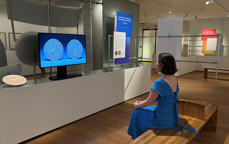 The AI-generated Oxford Crown NFT display in the Money Talks exhibition A visitor sitting looking at the new AI-generated Oxford Crown NFT on display in the Money Talks exhibition